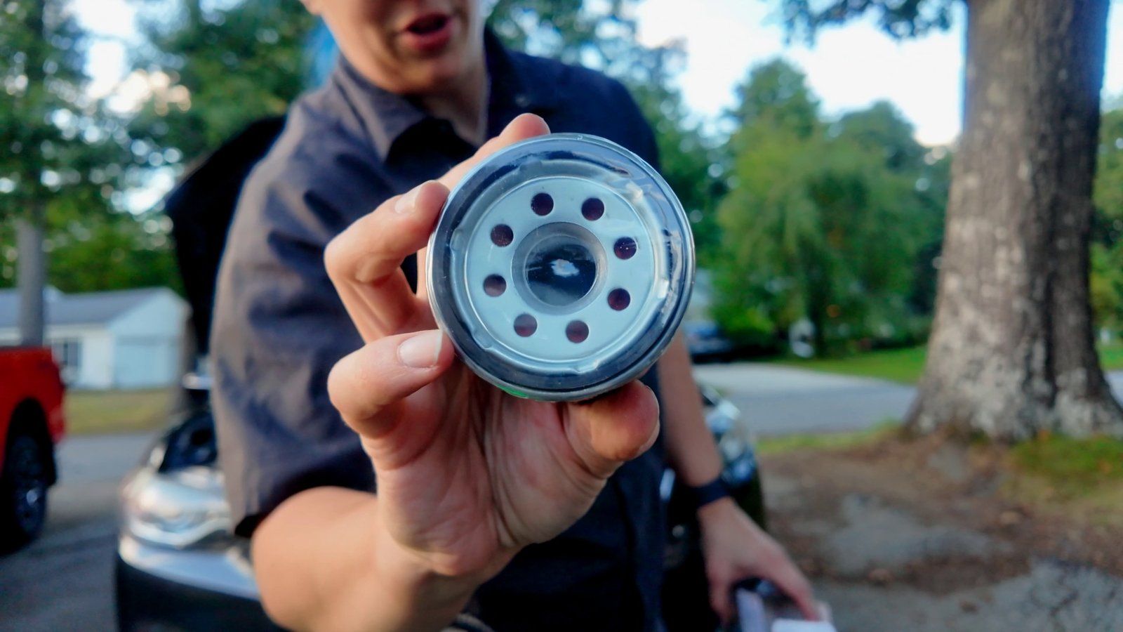 New Mazda oil filter held up to the camera showing the rubber gasket side
