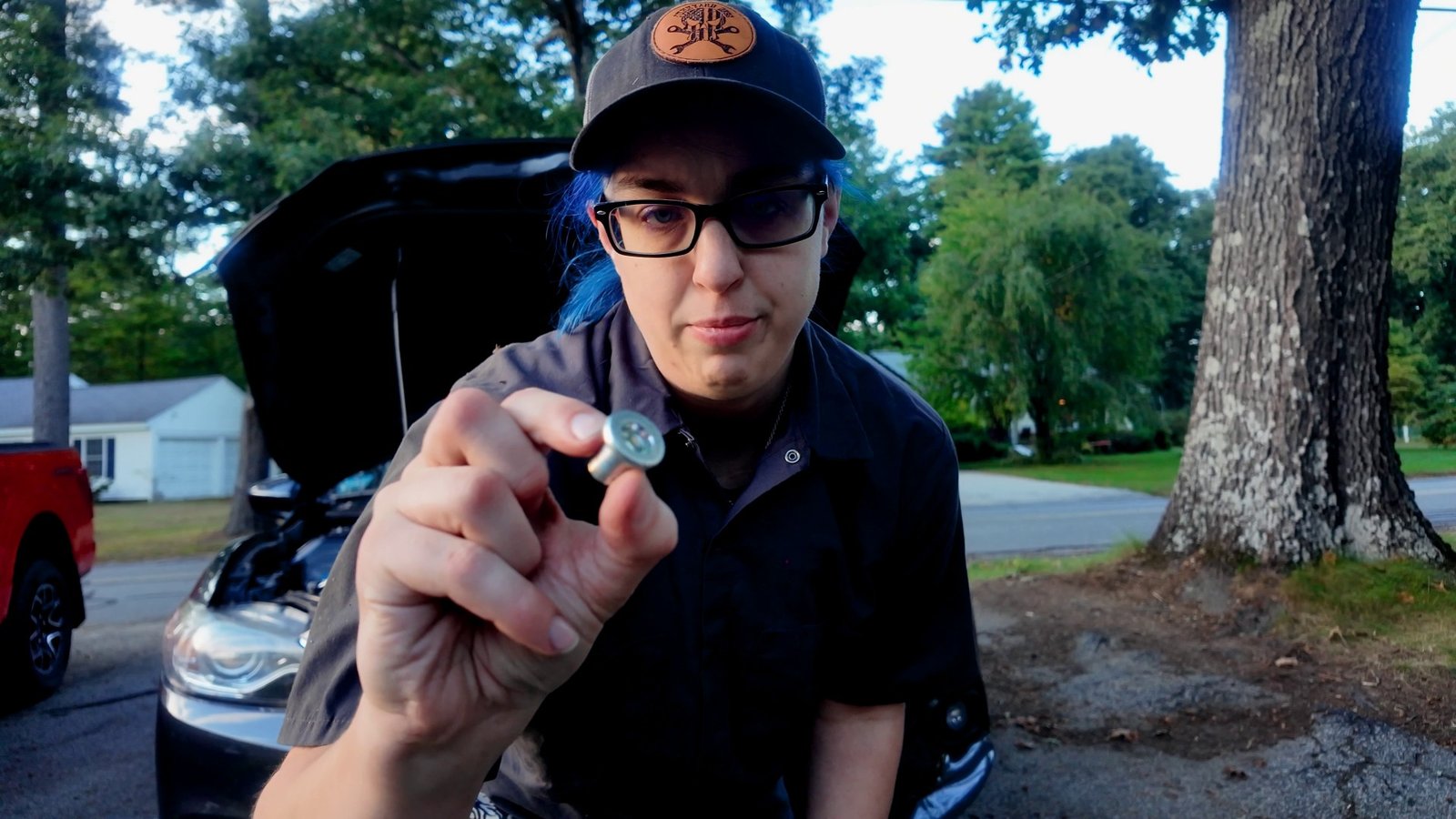 Emily holding the new Mazda 6 drain bolt with its crush washer