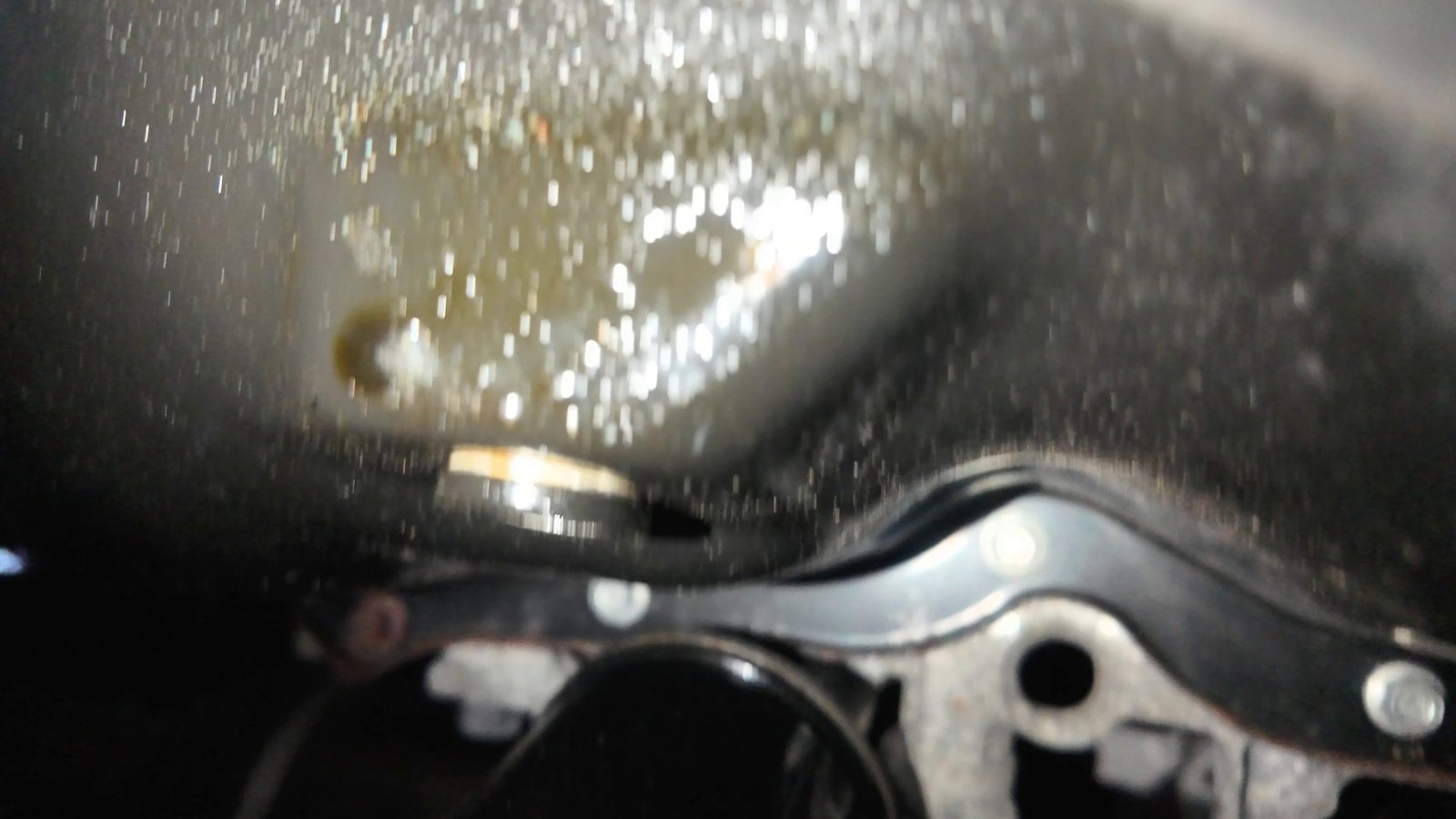 Oil pooled around the Mazda 6 drain plug on the oil pan